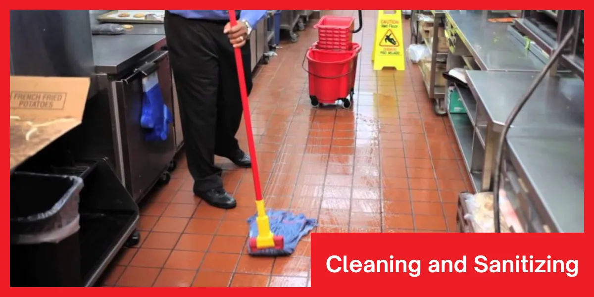 Person mopping a commercial kitchen floor with a caution wet floor sign nearby