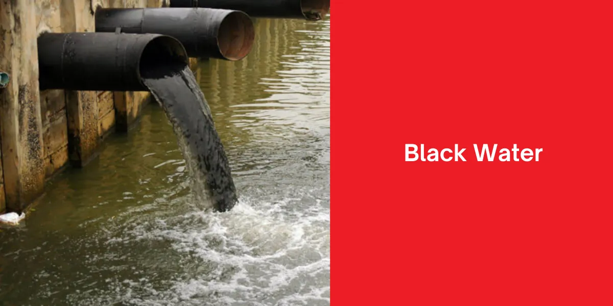 Black water flowing from large industrial pipes into a body of water, indicating contamination