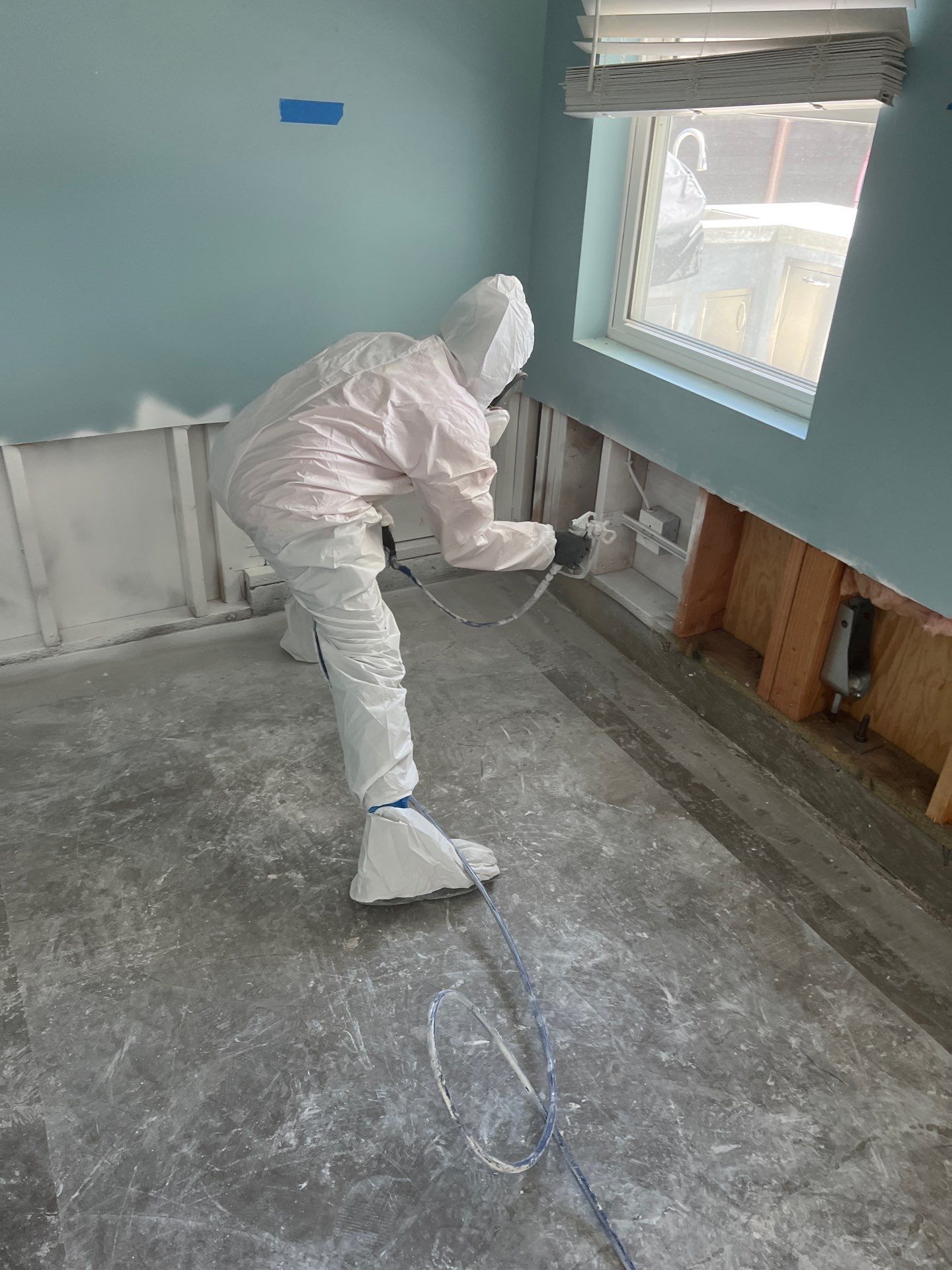 SOS Restoration technician applying antimicrobial treatment to exposed wall studs during mold remediation in Torrance, CA