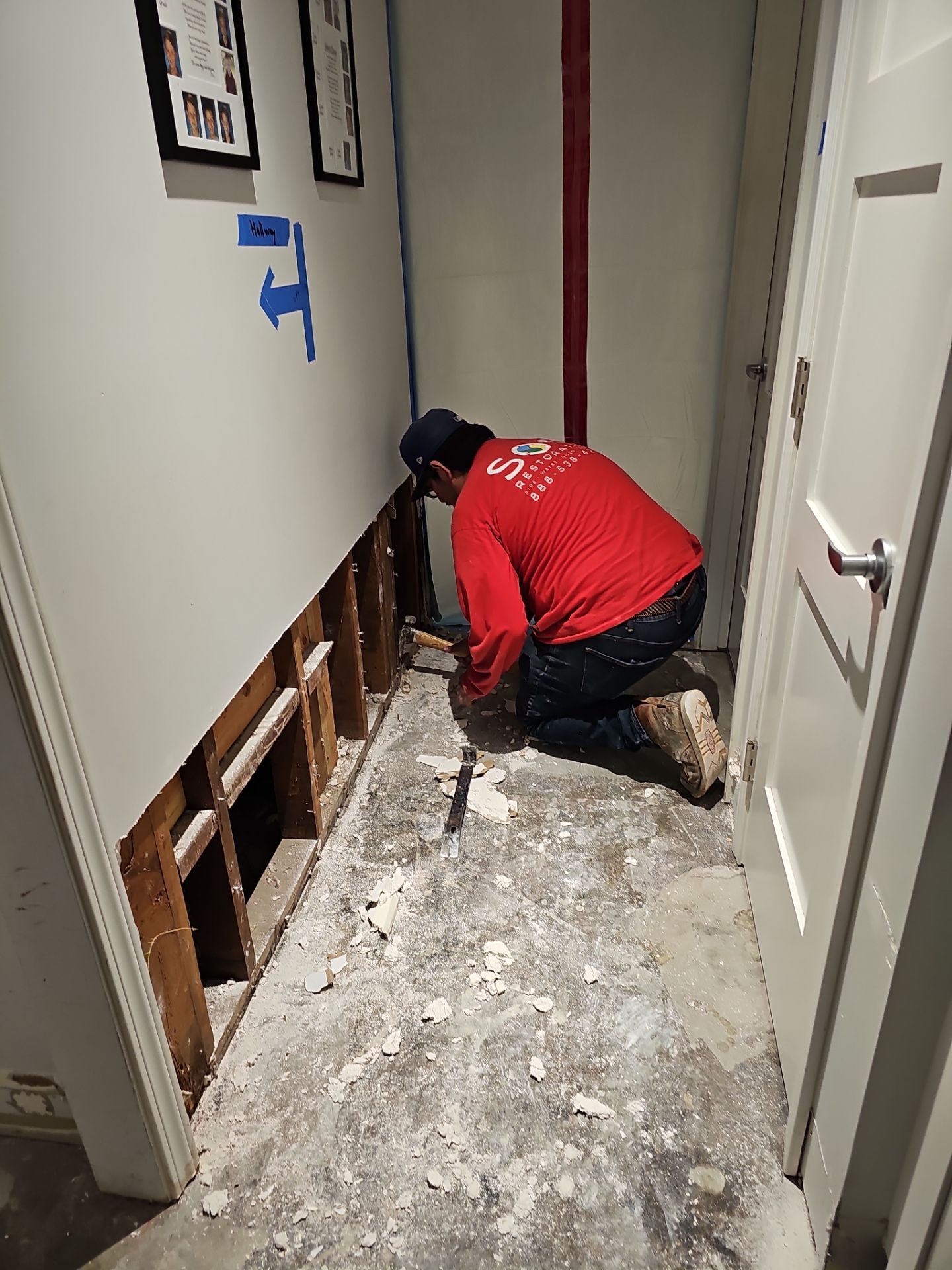 SOS Restoration technician spraying antimicrobial solution on exposed framing during mold remediation in Torrance, CA